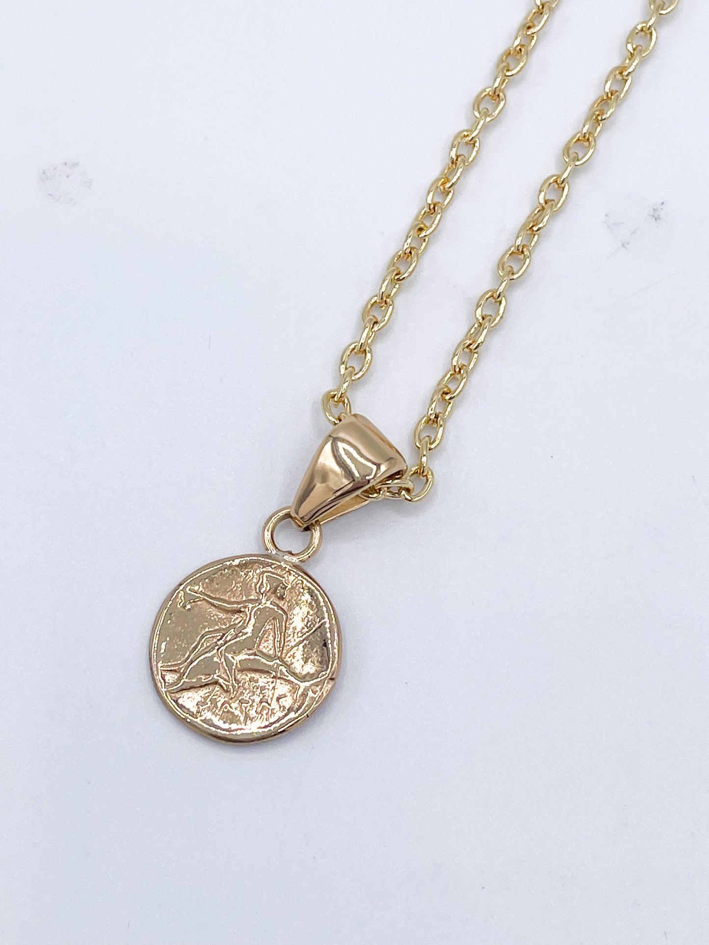 Boy on horse/dolphins coin pendant -