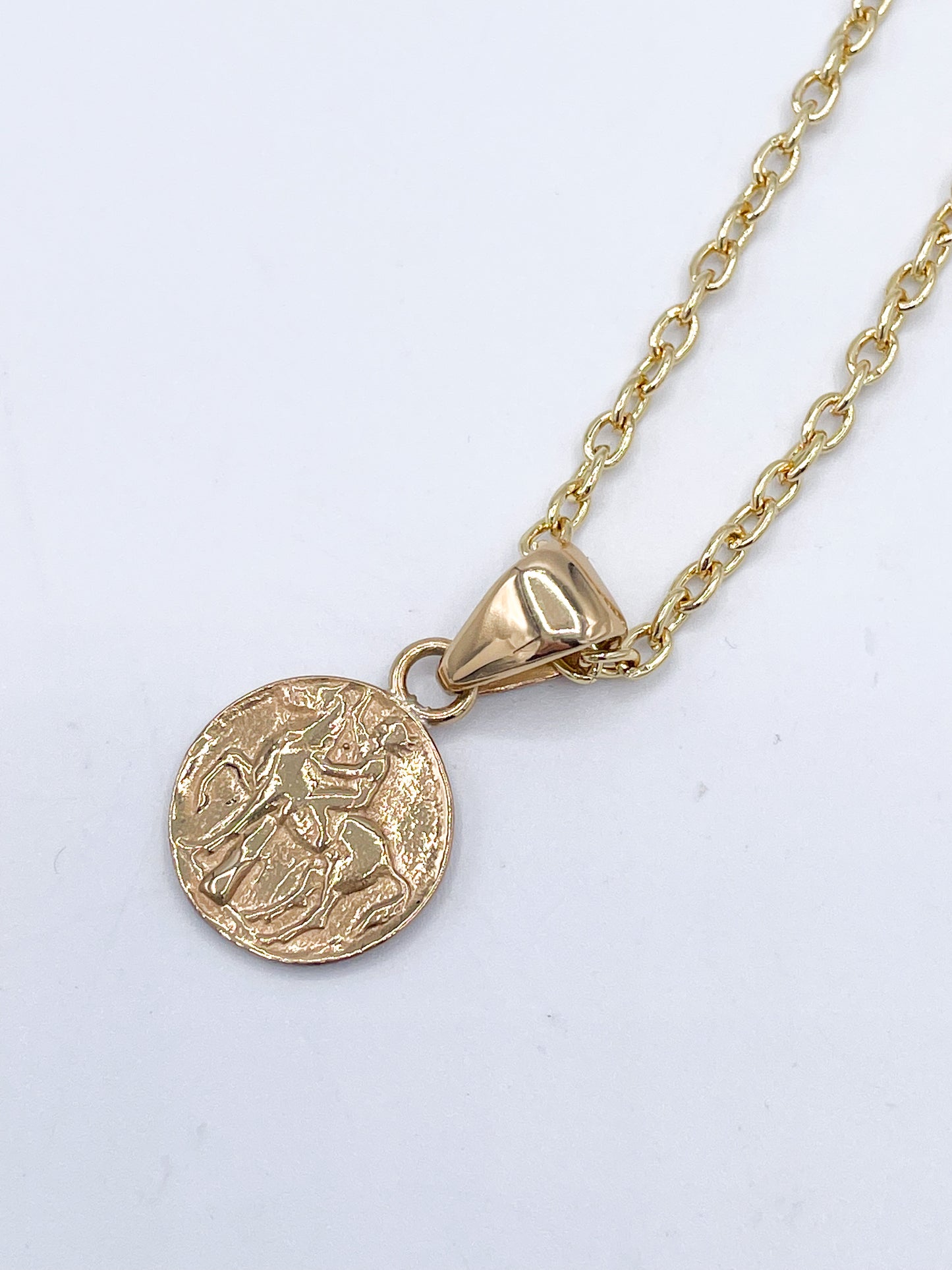 Boy on horse/dolphins coin pendant -